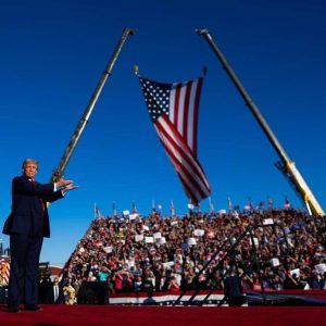 trump by flags and crane